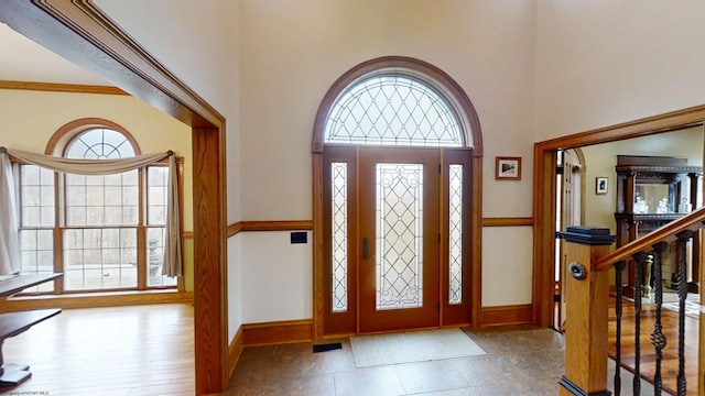 foyer with visible vents, a towering ceiling, baseboards, and stairs