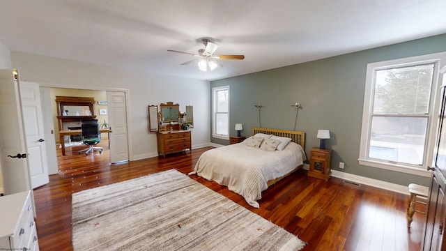 bedroom with dark wood-style floors, baseboards, and a ceiling fan