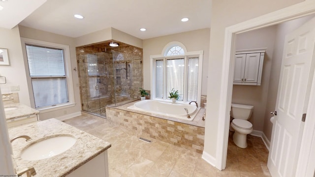 full bathroom featuring a garden tub, toilet, vanity, baseboards, and a shower stall