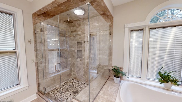 full bathroom with a garden tub and a shower stall