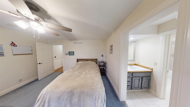 bedroom featuring baseboards, visible vents, ceiling fan, and a sink