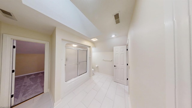 full bath with baseboards, visible vents, toilet, and bath / shower combo with glass door