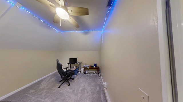 office space featuring lofted ceiling, ceiling fan, carpet flooring, and baseboards