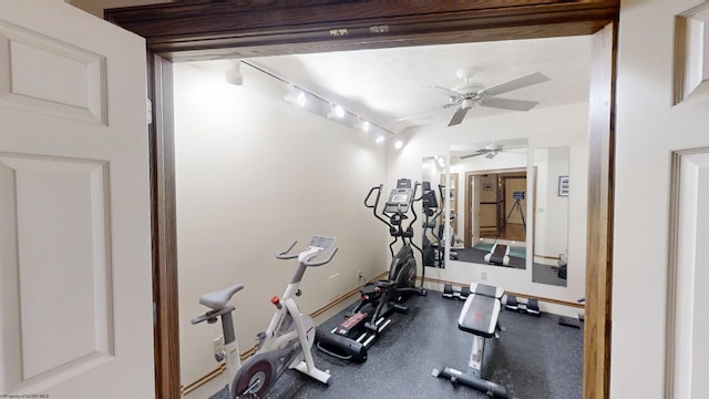 workout room featuring track lighting, baseboards, and a ceiling fan