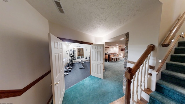 interior space with a textured ceiling and visible vents