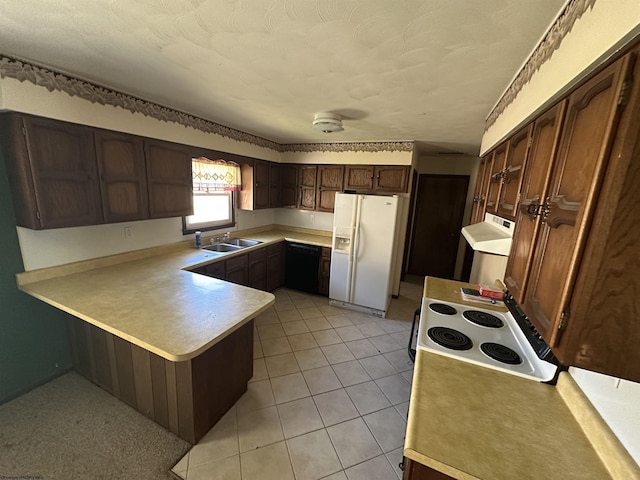 kitchen featuring a peninsula, light countertops, white fridge with ice dispenser, a sink, and light tile patterned flooring