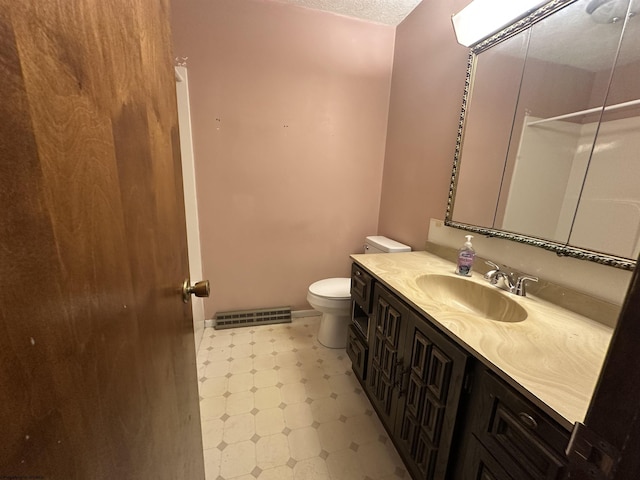 bathroom with a textured ceiling, toilet, visible vents, vanity, and tile patterned floors