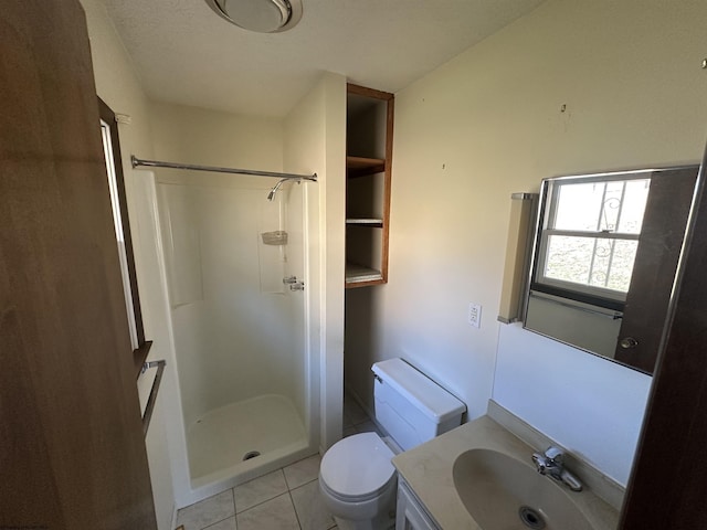 full bathroom featuring a stall shower, tile patterned flooring, vanity, and toilet