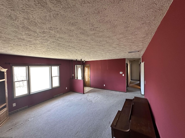 interior space with carpet floors, visible vents, and a textured ceiling