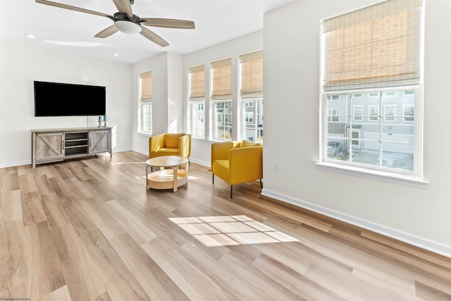 sitting room featuring ceiling fan, baseboards, and wood finished floors