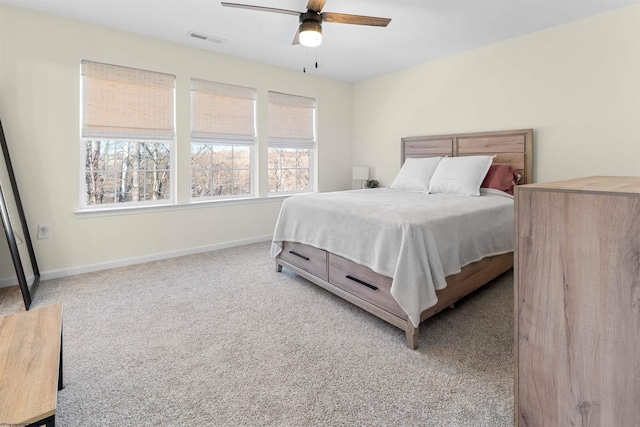 bedroom with a ceiling fan, baseboards, visible vents, and carpet flooring