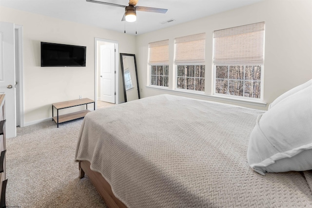 bedroom featuring carpet floors, baseboards, visible vents, and a ceiling fan