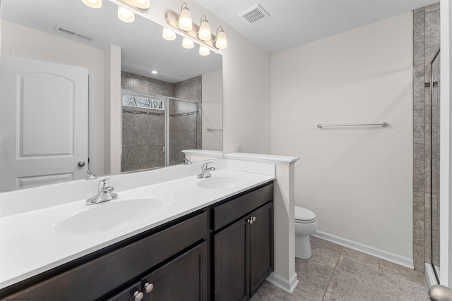 bathroom with toilet, a sink, and visible vents