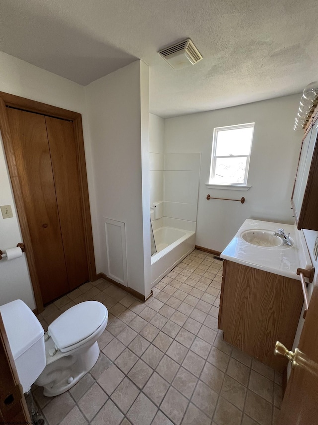 bathroom featuring visible vents, toilet, vanity, a textured ceiling, and tile patterned flooring