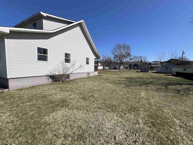 view of side of home with a lawn