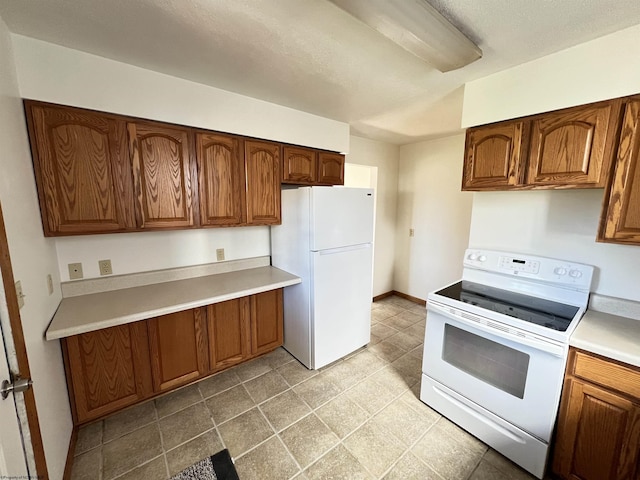 kitchen featuring light countertops, white appliances, and brown cabinetry