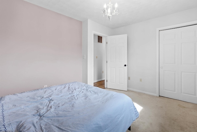 bedroom featuring baseboards, visible vents, a chandelier, and light colored carpet