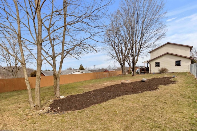 view of yard featuring a fire pit and a fenced backyard