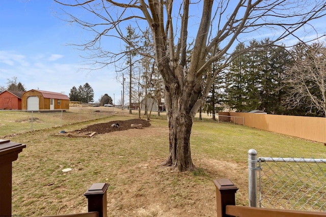 view of yard with a garage and fence