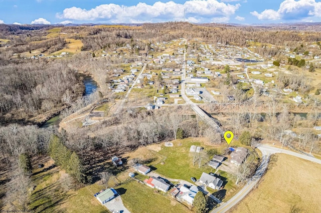 birds eye view of property featuring a wooded view