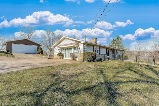 single story home with an outbuilding, a garage, covered porch, a chimney, and a front yard