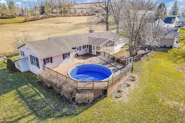 view of pool with a fenced in pool, a patio, fence, and a lawn