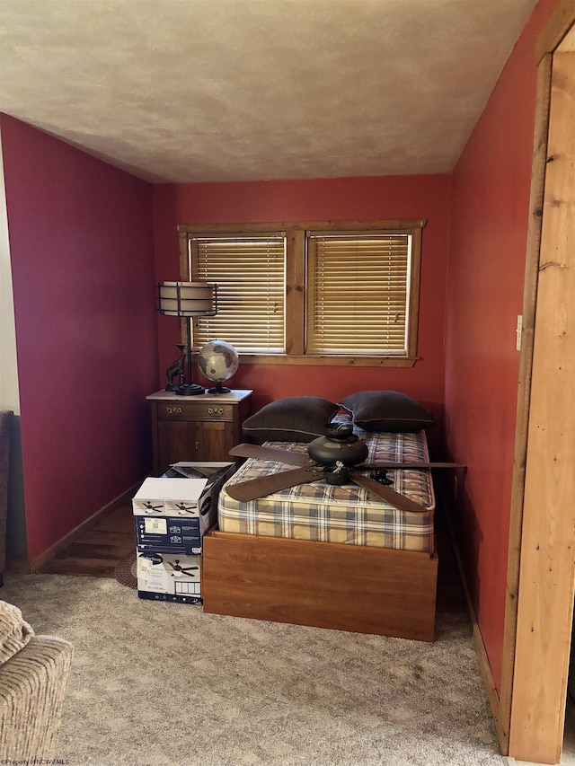 carpeted bedroom featuring baseboards