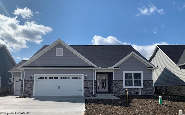 craftsman inspired home featuring a garage and concrete driveway