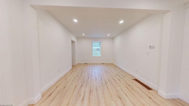 unfurnished room with light wood-style floors, visible vents, baseboards, and recessed lighting