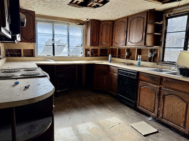 kitchen with black dishwasher, light countertops, and open shelves