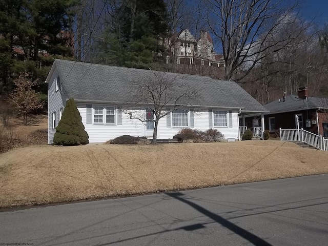 view of front of house featuring a porch and roof with shingles