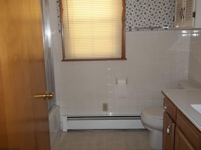 full bathroom with a baseboard radiator, toilet, tile walls, and vanity