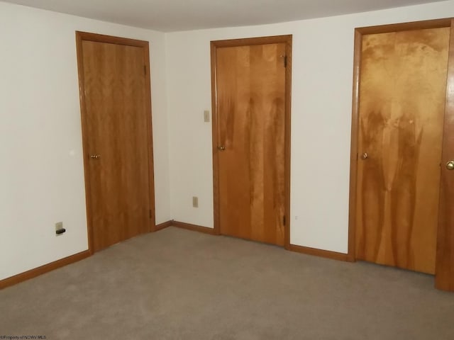 unfurnished bedroom with baseboards and carpet floors