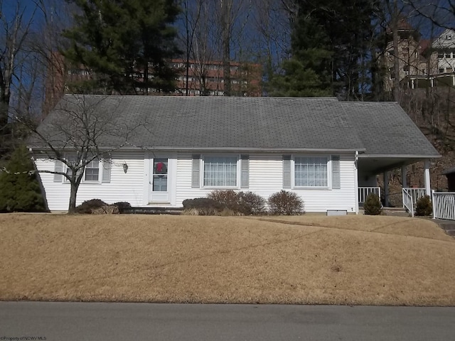 view of front of home featuring a carport, a porch, and roof with shingles