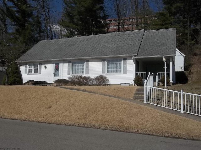 ranch-style house with fence and a shingled roof