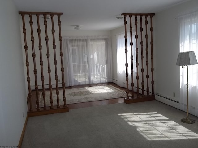 spare room with a baseboard heating unit and a wealth of natural light