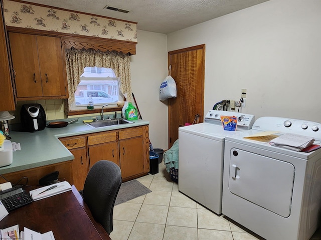 168 Locust Heights Dr, Clarksburg, WV 26301 - clothes washing area with washing machine and clothes dryer, visible vents, light tile patterned floors, a textured ceiling, and a sink