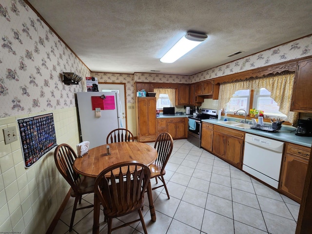 168 Locust Heights Dr, Clarksburg, WV 26301 - kitchen with wallpapered walls, dishwasher, wainscoting, electric range, and a sink