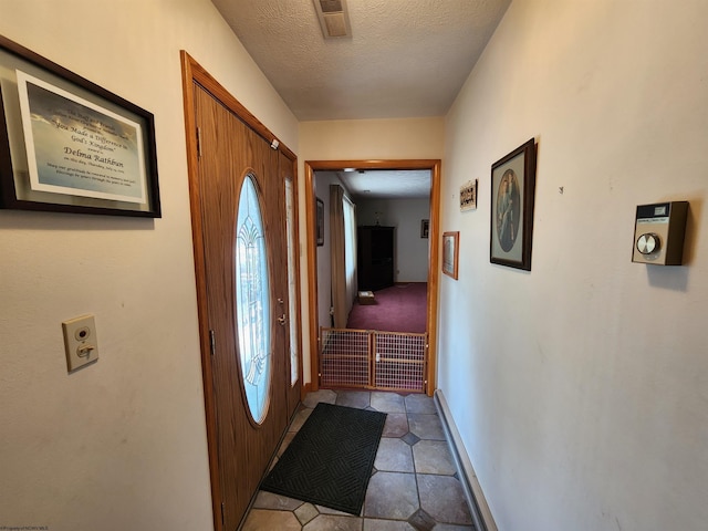 168 Locust Heights Dr, Clarksburg, WV 26301 - entryway featuring tile patterned floors, baseboards, visible vents, and a textured ceiling