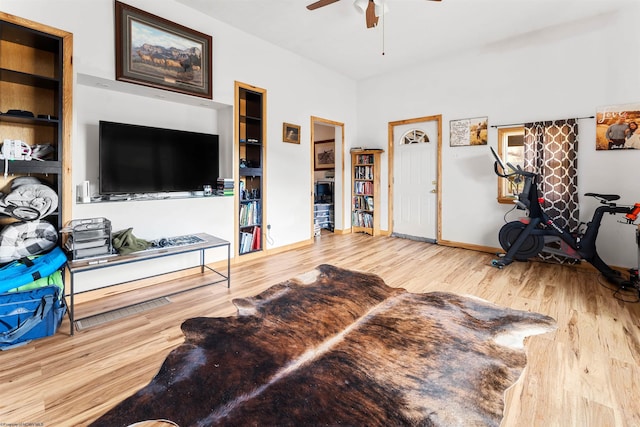 living room featuring a ceiling fan, wood finished floors, and baseboards