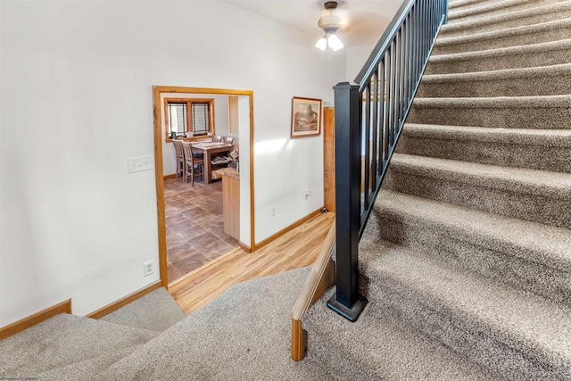 stairs with baseboards and wood finished floors