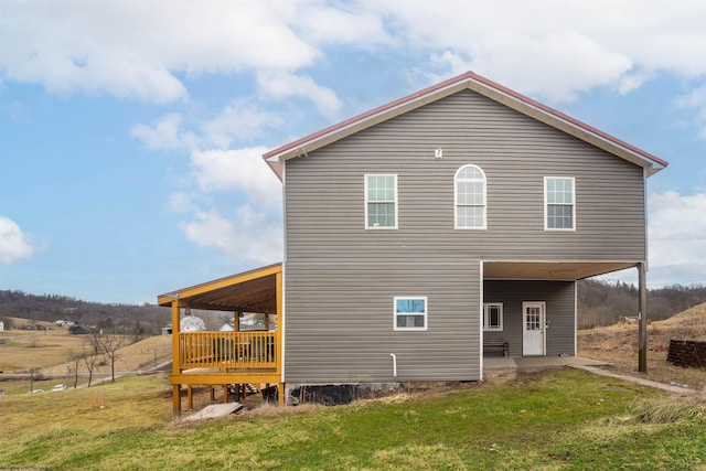 back of house with a patio and a yard