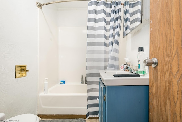 full bathroom with toilet, vanity, and shower / tub combo