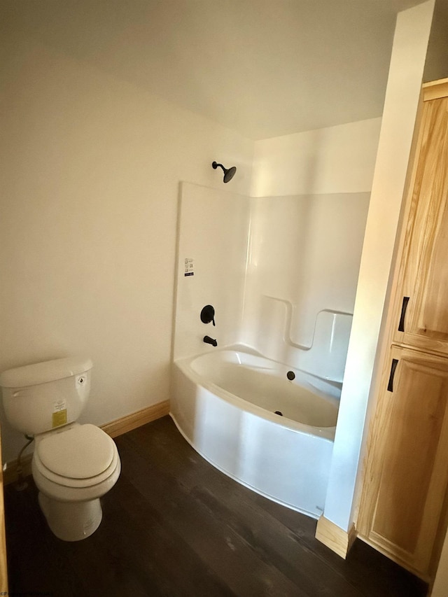 full bathroom with toilet, shower / bathtub combination, baseboards, and wood finished floors