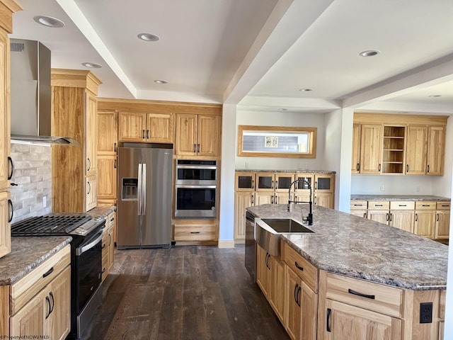 kitchen with open shelves, dark wood finished floors, stainless steel appliances, wall chimney exhaust hood, and a sink