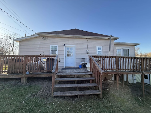 back of property with cooling unit and a deck