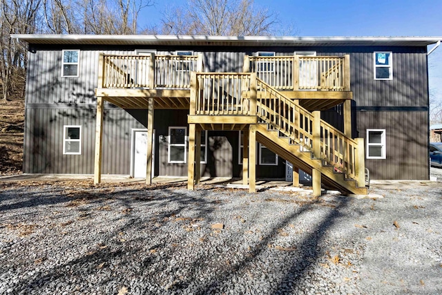 back of property with stairway and a wooden deck