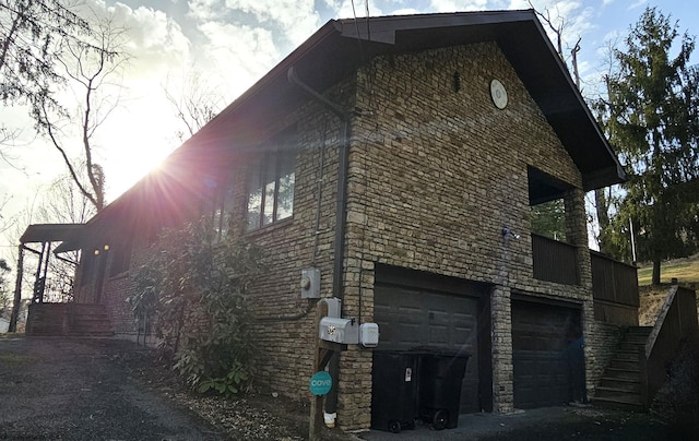 view of home's exterior with a garage and stone siding