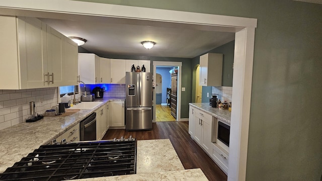 kitchen with dishwasher, gas stovetop, light countertops, and stainless steel fridge with ice dispenser