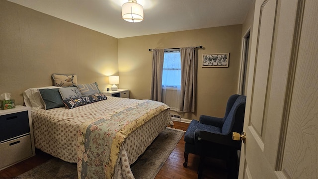 bedroom featuring dark wood-style floors and baseboards